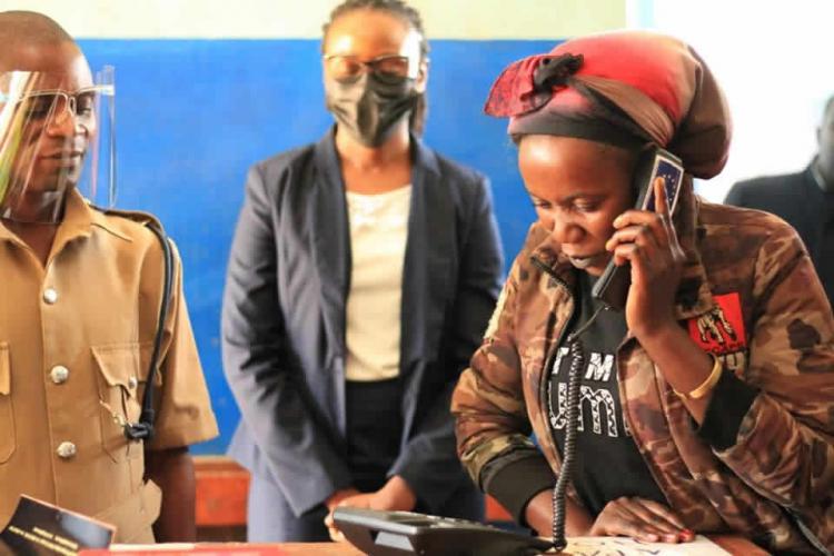 Mchinji Police Station client trying out the toll free phone