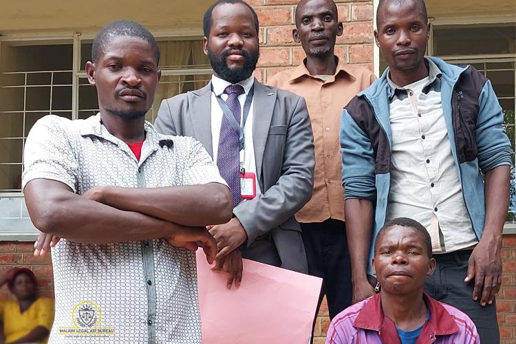 Counsel Dallas (in gray suit) with the 4 clients