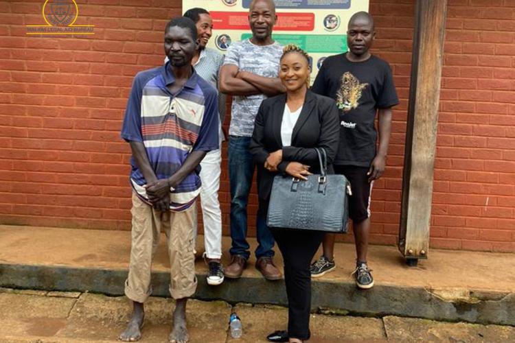 Senior Legal Aid Advocate Chikondi Kambuwa with the four after court