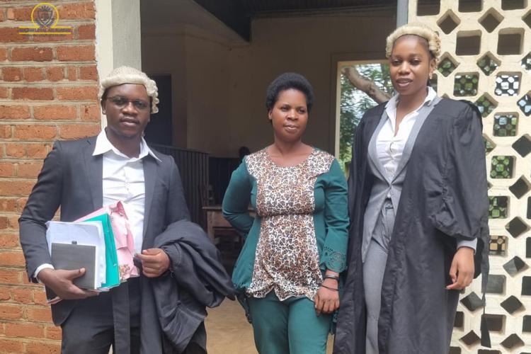 Grace Katunga (center) with counsel after court